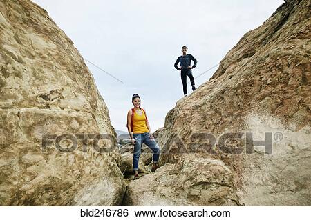 Portrait of smiling women posing on rock formation View Large Photo Image Stock Photograph - Portrait of smiling women posing on rock formation. Fotosearch