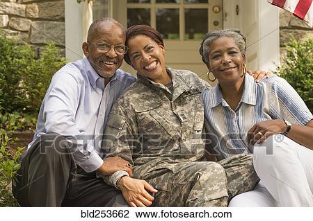 Portrait of soldier sitting on front stoop with parents View Large Photo Image Stock Image - Portrait of soldier sitting on front stoop with parents. Fotosearch