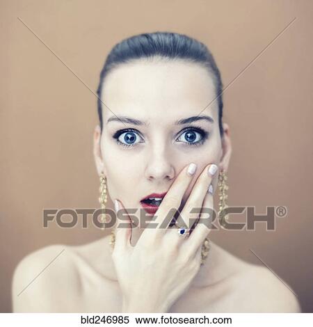Stock Photography - Portrait of surprised Caucasian woman wearing earrings. Fotosearch
