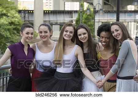 Stock Photograph - Portrait of young woman posing outdoors. Fotosearch