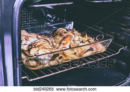 Potato and chicken casserole baking in oven View Large Photo Image Stock Photography - Potato and chicken casserole baking in oven. Fotosearch