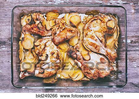 Stock Photograph - Potato and chicken casserole in baking dish. Fotosearch