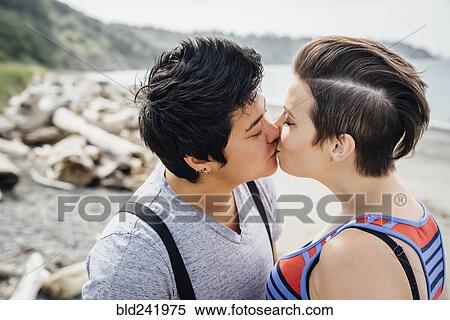 Pregnant lesbian couple kissing on beach View Large Photo Image Stock Photography - Pregnant lesbian couple kissing on beach. Fotosearch