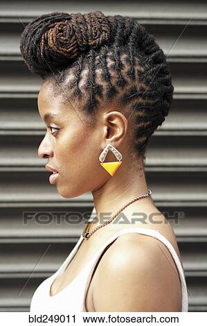 Profile of African American woman with braids near metal wall View Large Photo Image Stock Image - Profile of African American woman with braids near metal wall. Fotosearch