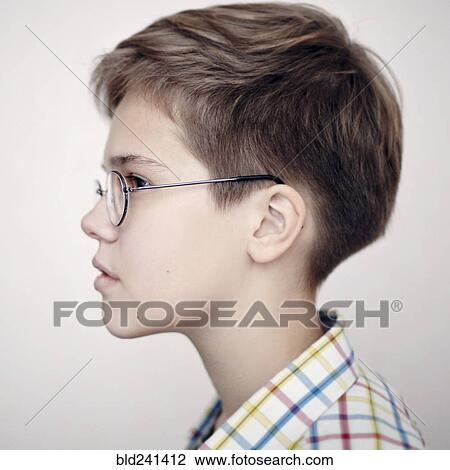 Stock Image - Profile of Caucasian boy wearing eyeglasses. Fotosearch