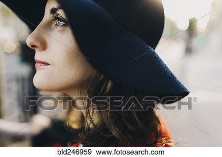 Stock Photo - Profile of Caucasian woman wearing hat. Fotosearch