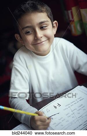 Proud Hispanic boy practicing writing alphabet View Large Photo Image Stock Image - Proud Hispanic boy practicing writing alphabet. Fotosearch