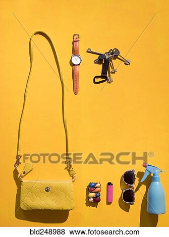 Purse and summer accessories on yellow background View Large Photo Image Stock Photo - Purse and summer accessories on yellow background. Fotosearch