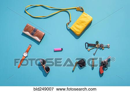 "Purse, wallet, gun and accessories on blue background" View Large Photo Image Stock Photo - "Purse, wallet, gun and accessories on blue background". Fotosearch