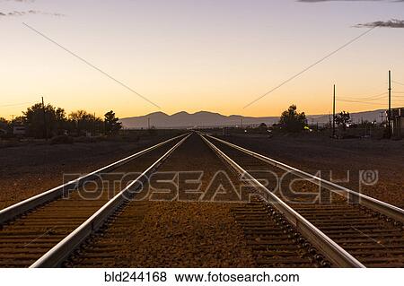 Railroad tracks in mountain landscape at sunset View Large Photo Image Stock Photo - Railroad tracks in mountain landscape at sunset. Fotosearch