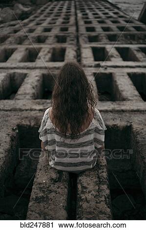 Rear view of Caucasian girl sitting on structure View Large Photo Image Stock Image - Rear view of Caucasian girl sitting on structure. Fotosearch