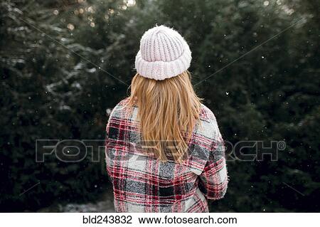 Rear view of Caucasian woman near trees in snow View Large Photo Image Stock Image - Rear view of Caucasian woman near trees in snow. Fotosearch