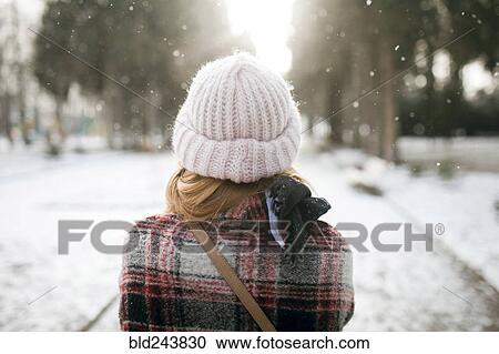 Rear view of Caucasian woman outdoors in snow View Large Photo Image Stock Image - Rear view of Caucasian woman outdoors in snow. Fotosearch