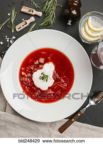 Stock Photo - Red soup in bowl with sour cream. Fotosearch