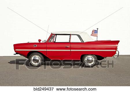 Red vintage convertible car with American flag View Large Photo Image Stock Photo - Red vintage convertible car with American flag. Fotosearch
