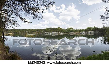 Reflection of clouds in still lake View Large Photo Image Stock Image - Reflection of clouds in still lake. Fotosearch