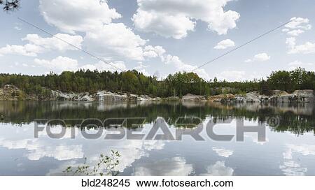 Reflection of clouds in still lake View Large Photo Image Stock Photography - Reflection of clouds in still lake. Fotosearch