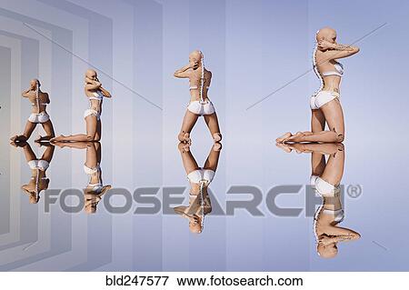 Stock Photo - Reflections of kneeling cyborg women. Fotosearch