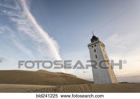 Stock Photography - Remote tower leaning in sand dunes. Fotosearch