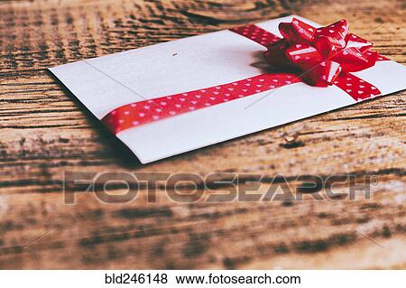 Ribbon on valentine card on wooden table View Large Photo Image Stock Photo - Ribbon on valentine card on wooden table. Fotosearch