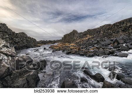 Stock Photo - River flowing over rocks, Pingvellir, Southern Iceland, Iceland. Fotosearch