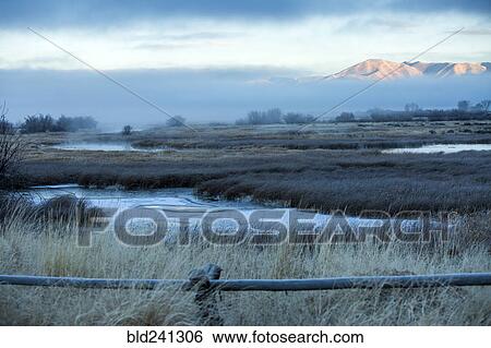Stock Photograph - River in foggy mountain landscape. Fotosearch