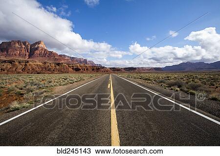 Stock Image - Road to distant desert landscape. Fotosearch