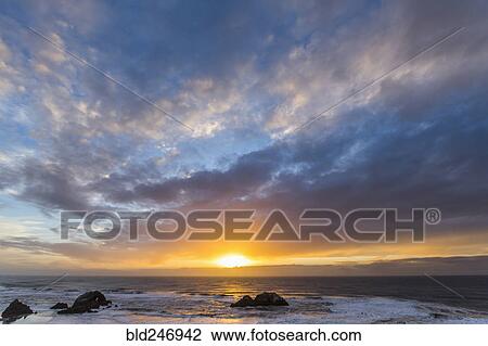 Rocks in ocean at sunset View Large Photo Image Stock Image - Rocks in ocean at sunset. Fotosearch