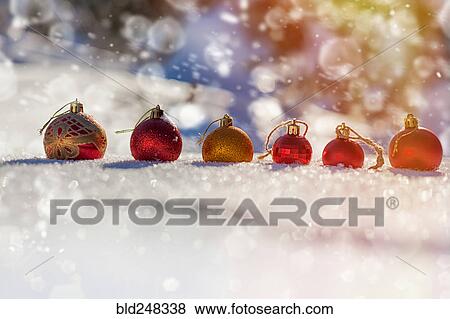Row of Christmas ornaments in the snow View Large Photo Image Stock Photo - Row of Christmas ornaments in the snow. Fotosearch