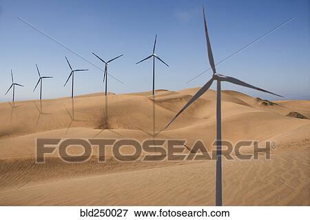 Stock Photo - Row of wind turbines in desert. Fotosearch