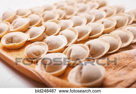 Stock Photo - Rows of dumplings on towel. Fotosearch