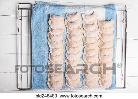 Rows of pierogies on towel View Large Photo Image Stock Image - Rows of pierogies on towel. Fotosearch