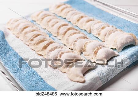 Rows of pierogies on towel View Large Photo Image Stock Photograph - Rows of pierogies on towel. Fotosearch