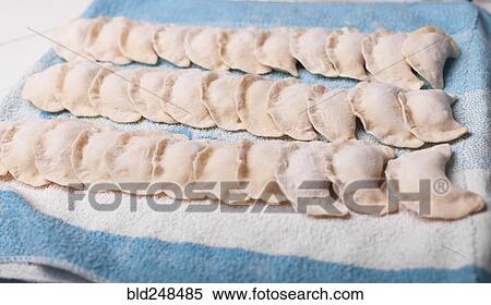 Rows of pierogies on towel View Large Photo Image Stock Photography - Rows of pierogies on towel. Fotosearch