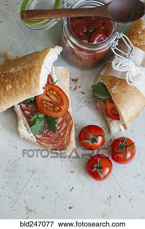 Sandwich near tomatoes and jar View Large Photo Image Stock Photo - Sandwich near tomatoes and jar. Fotosearch