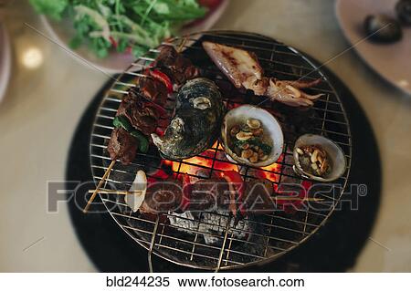 Seafood cooking on grille View Large Photo Image Stock Photography - Seafood cooking on grille. Fotosearch