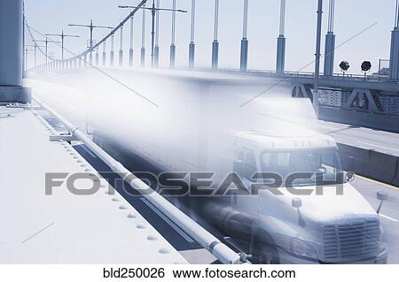 Semi-truck speeding on bridge View Large Photo Image Stock Photograph - Semi-truck speeding on bridge. Fotosearch