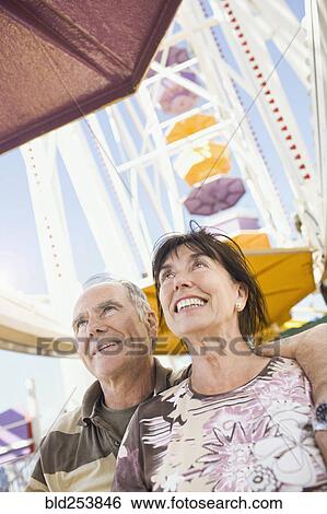 Stock Photograph - Senior couple in amusement park. Fotosearch