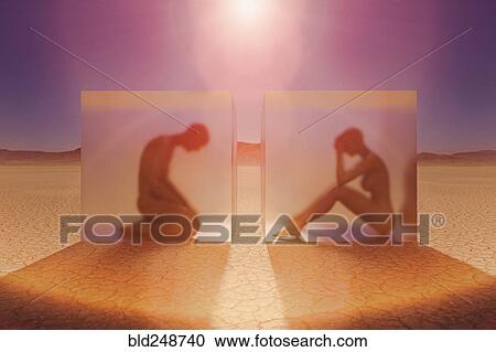 Stock Image - Separated couple in suspended animation in desert. Fotosearch