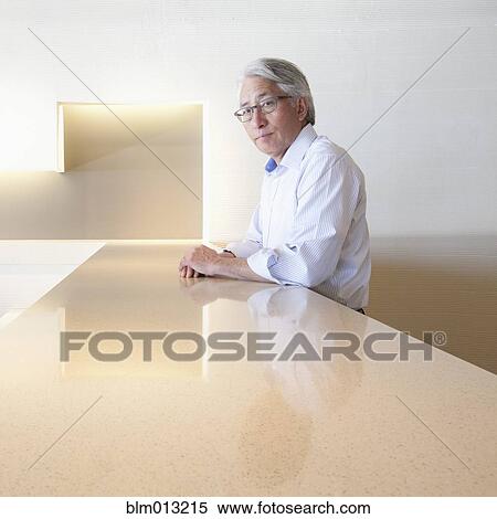 Stock Photography - Serious Asian businessman in office. Fotosearch