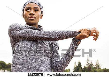 Serious Black athlete stretching arms View Large Photo Image Stock Image - Serious Black athlete stretching arms. Fotosearch