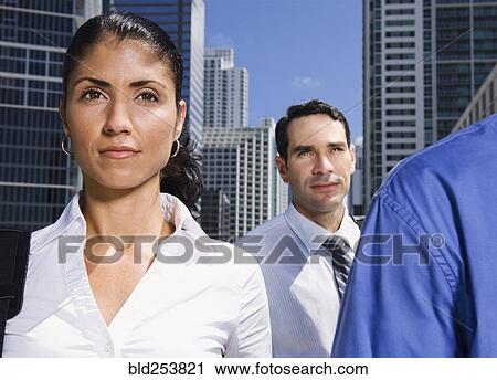 Stock Image - Serious business people in city. Fotosearch