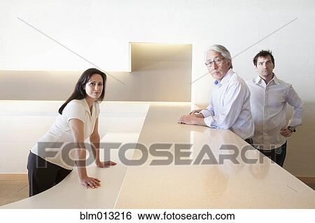 Stock Photograph - Serious business people in office. Fotosearch