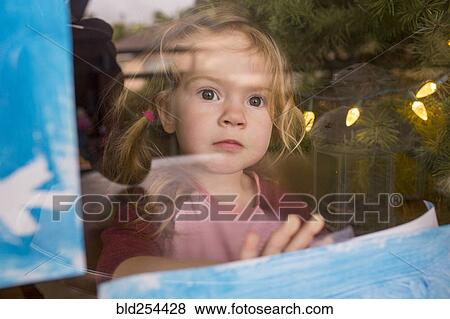 Serious Caucasian girl leaning on window View Large Photo Image Stock Photo - Serious Caucasian girl leaning on window. Fotosearch