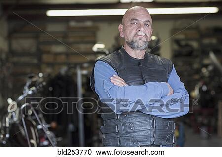 Stock Image - Serious Caucasian man with arms crossed. Fotosearch