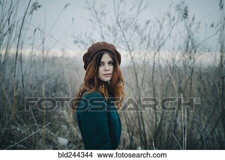 Serious Caucasian woman standing in field View Large Photo Image Picture - Serious Caucasian woman standing in field. Fotosearch