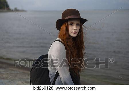 Serious Caucasian woman standing near ocean View Large Photo Image Stock Photo - Serious Caucasian woman standing near ocean. Fotosearch
