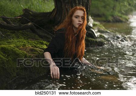 Serious Caucasian woman standing waist deep in water View Large Photo Image Stock Image - Serious Caucasian woman standing waist deep in water. Fotosearch