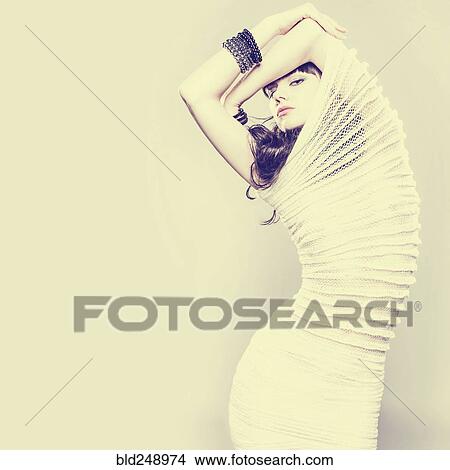 Picture - Serious Caucasian woman wearing ribbed dress. Fotosearch