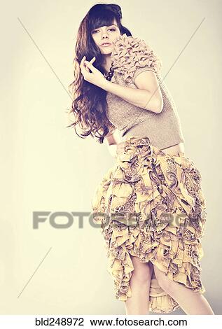 Stock Image - Serious Caucasian woman wearing ruffled skirt. Fotosearch